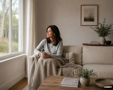Woman relaxing on a sofa by the window
