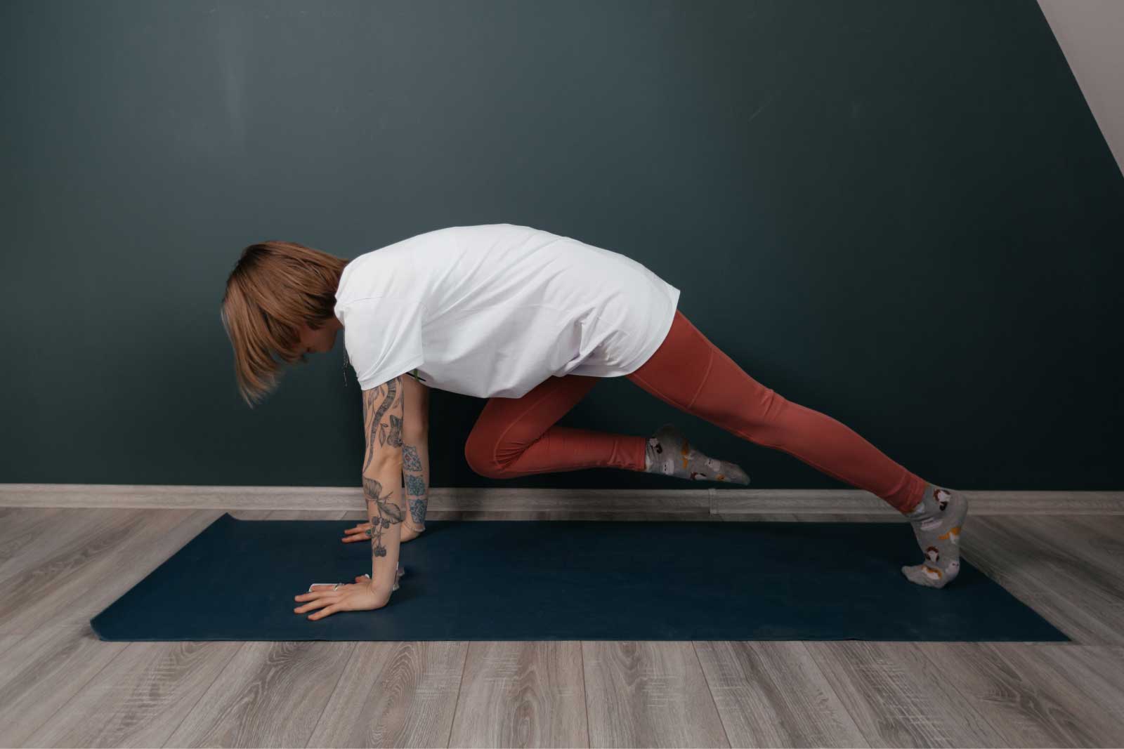 Woman doing a lunge stretch on a mat