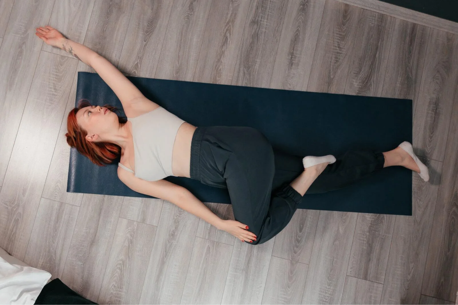 Woman doing a lying spinal twist stretch