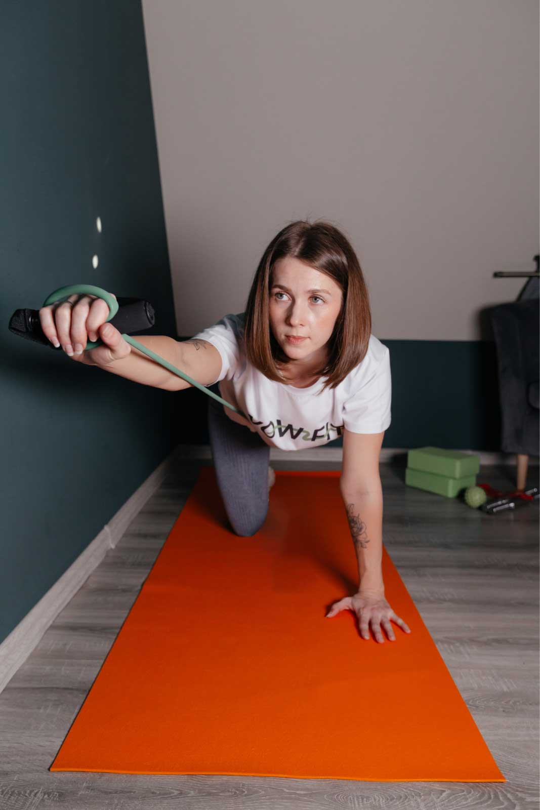 Woman stretching on an orange mat during a home workout